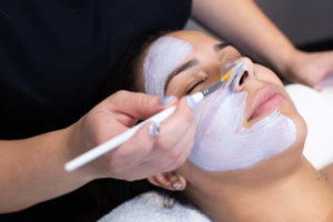 Woman receiving facial treatment