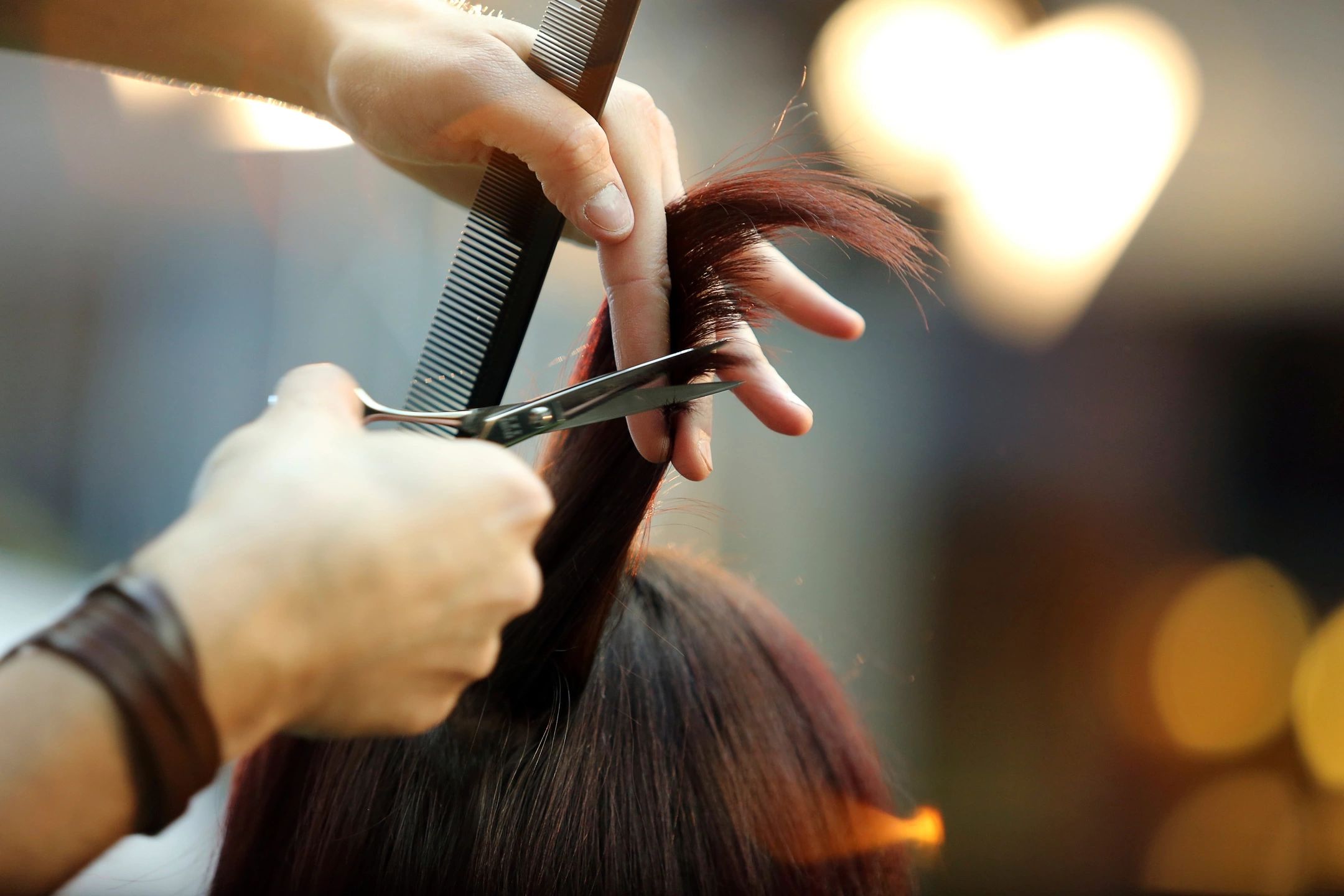 Barber preparing to cut woman's hair