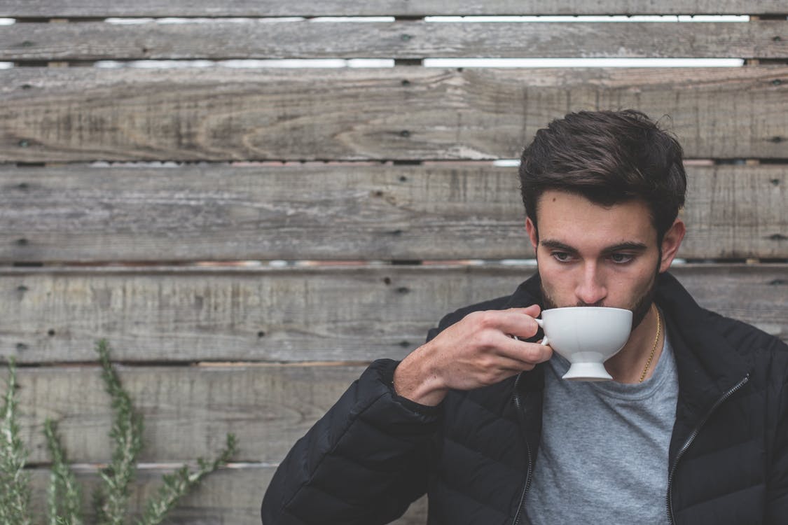 Young man sipping coffee at a cafe