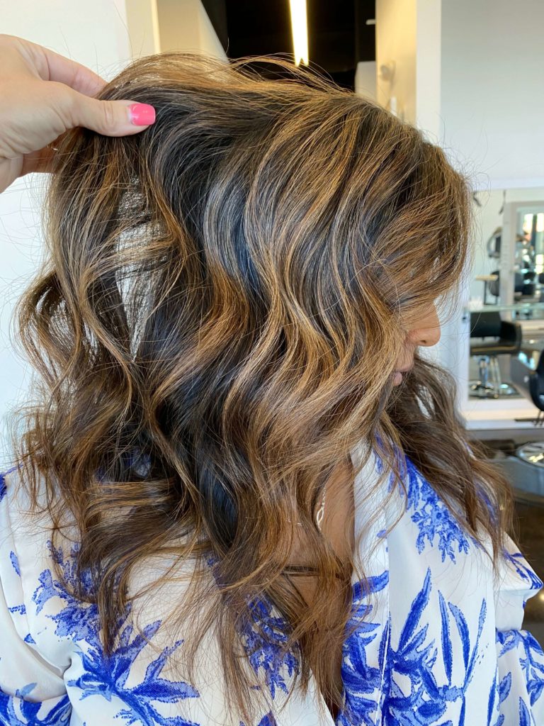 woman after hair appointment with highlights