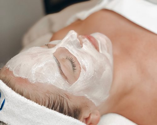 woman resting in spa bed after red carpet facial